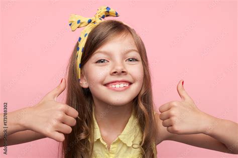 portrait of smiling <b>girl</b> showing <b>thumbs</b> up while sitting on table at school - <b>schoolgirl thumbs</b> stock pictures, royalty-free photos & images elevated view of a <b>girl</b> (11-12) wearing uniform and a 1st prize rosette on her jumper giving <b>thumbs</b> up - <b>schoolgirl thumbs</b> stock pictures, royalty-free photos & images. . Young and small girl thumbs